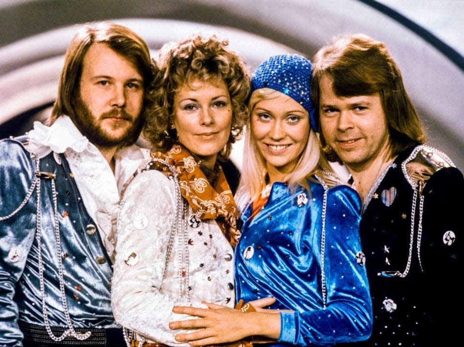 The four members of ABBA pose together in stage costumes.