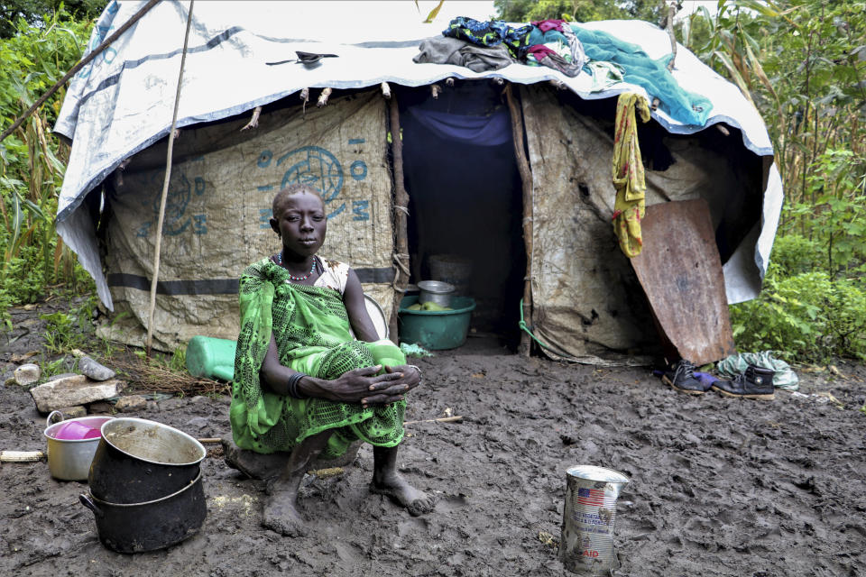 A young woman sits in front of her shelter after heavy rainfall and flooding destroyed her crops, in Lukurunyang in the Greater Pibor Administrative Area, South Sudan, Monday, Sept. 7, 2020. Flooding has affected well over a million people across East Africa, another calamity threatening food security on top of a historic locust outbreak and the coronavirus pandemic. (Tetiana Gaviuk/Medecins Sans Frontieres via AP)