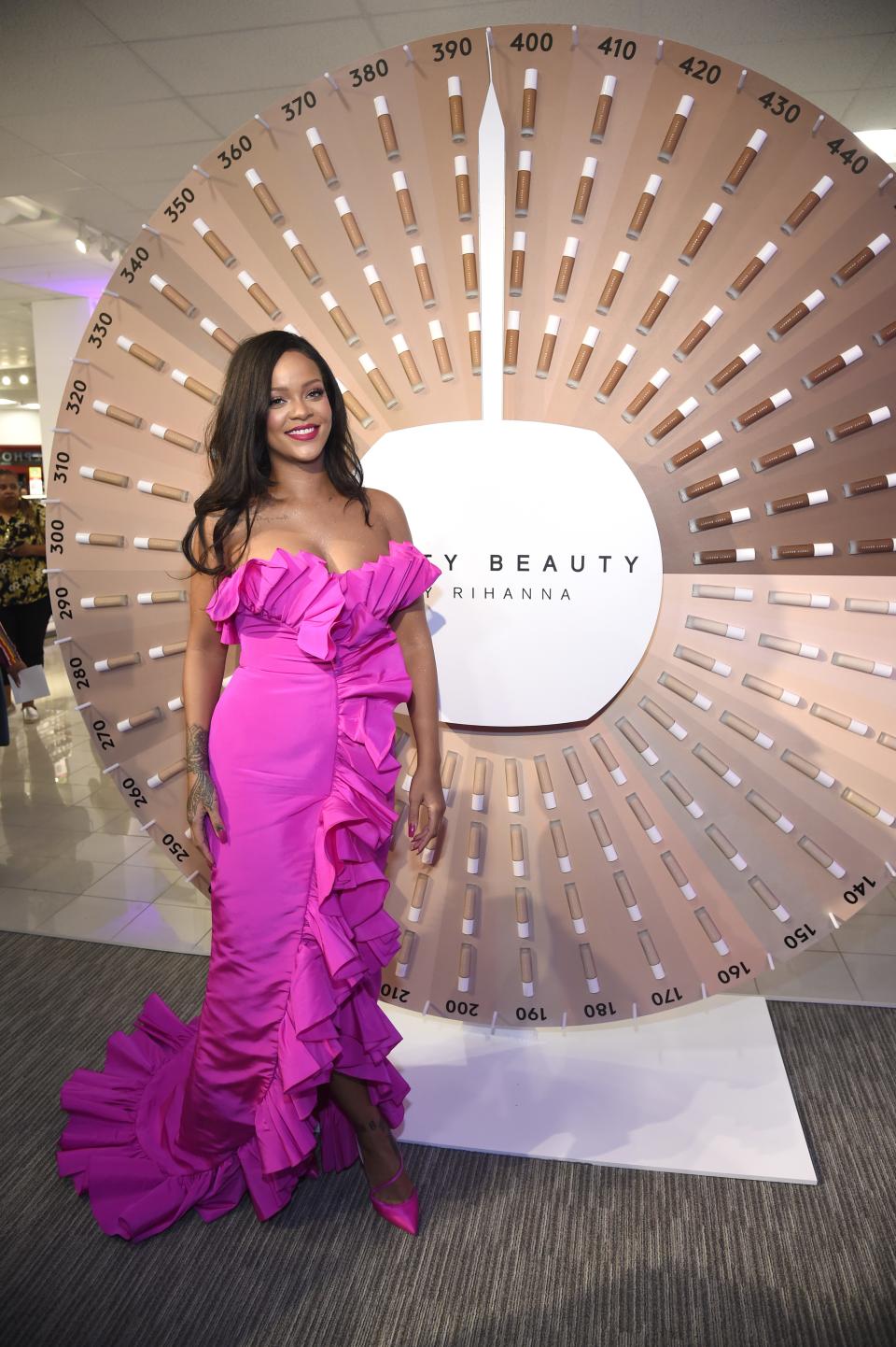 Rihanna wore an eye-popping fuchsia gown to the birthday bash of her cosmetics company, Fenty Beauty, on Friday night.