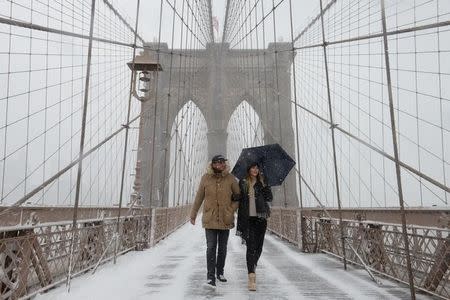 Two people walk over the Brooklyn Bridge during winter storm Niko in New York City, U.S., February 9, 2017. REUTERS/Stephanie Keith