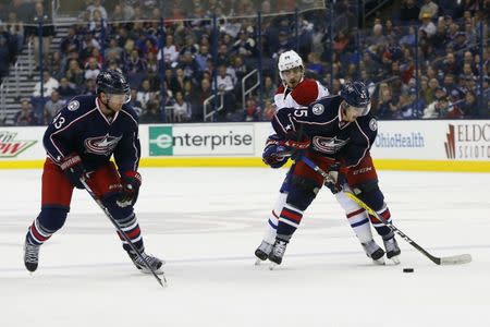 Nov 4, 2016; Columbus, OH, USA; Columbus Blue Jackets center Lukas Sedlak (45) steals the puck from Montreal Canadiens left wing Phillip Danault (24) during the third period at Nationwide Arena. Columbus shutout Montreal 10-0. Mandatory Credit: Russell LaBounty-USA TODAY Sports