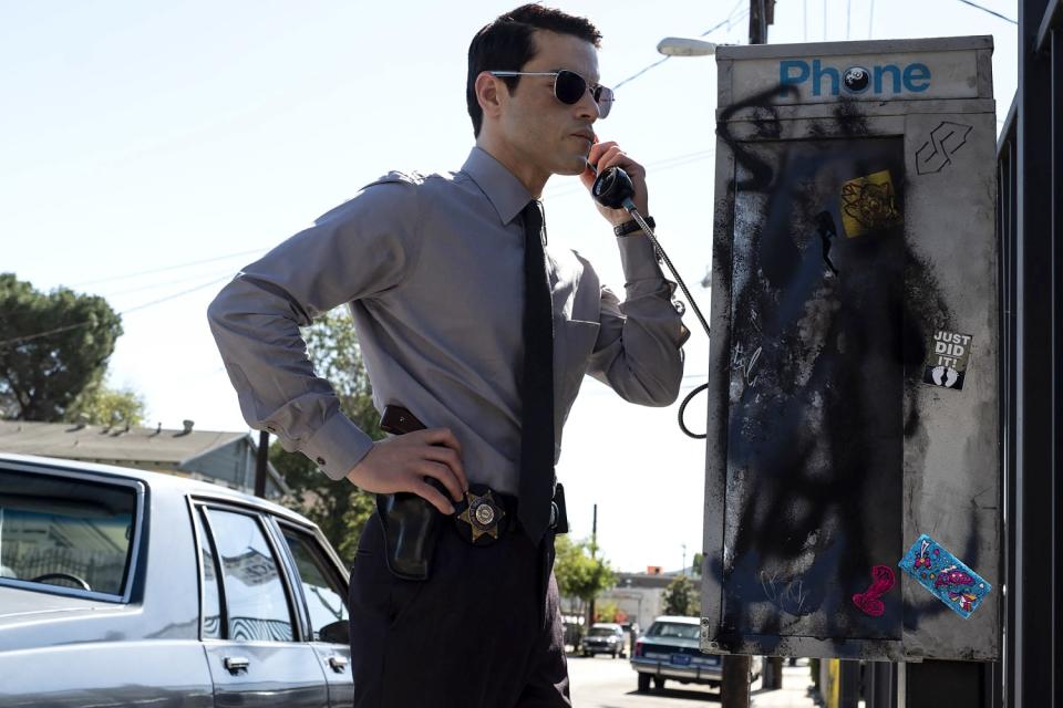 Malek as Jim Baxter at a phone booth