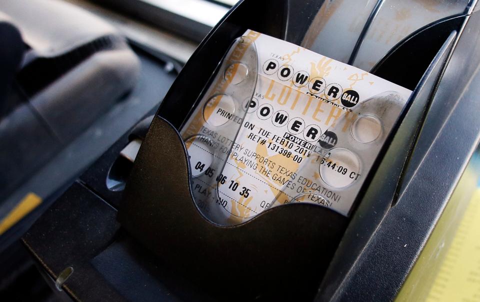 A Powerball ticket sits in the tray dispenser after being printed out for a customer at a Dallas convenience store in 2015.