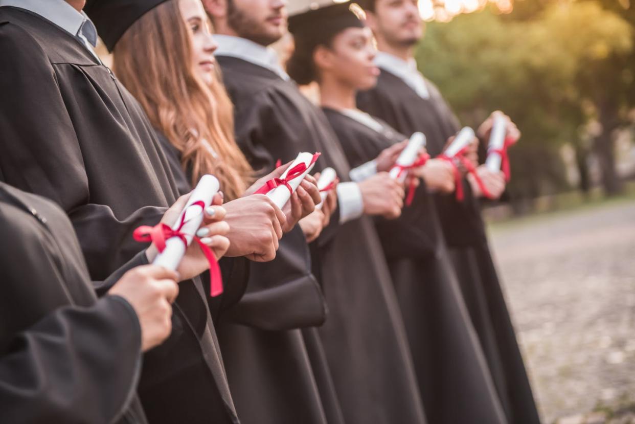 <span class="caption">Colleges are increasingly being judged on how many students graduate. But is tying funding to graduation rates the way to go?</span> <span class="attribution"><a class="link " href="https://www.shutterstock.com/image-photo/successful-graduates-academic-dresses-holding-diplomas-739232275" rel="nofollow noopener" target="_blank" data-ylk="slk:George Rudy/Shutterstock.com;elm:context_link;itc:0;sec:content-canvas">George Rudy/Shutterstock.com</a></span>
