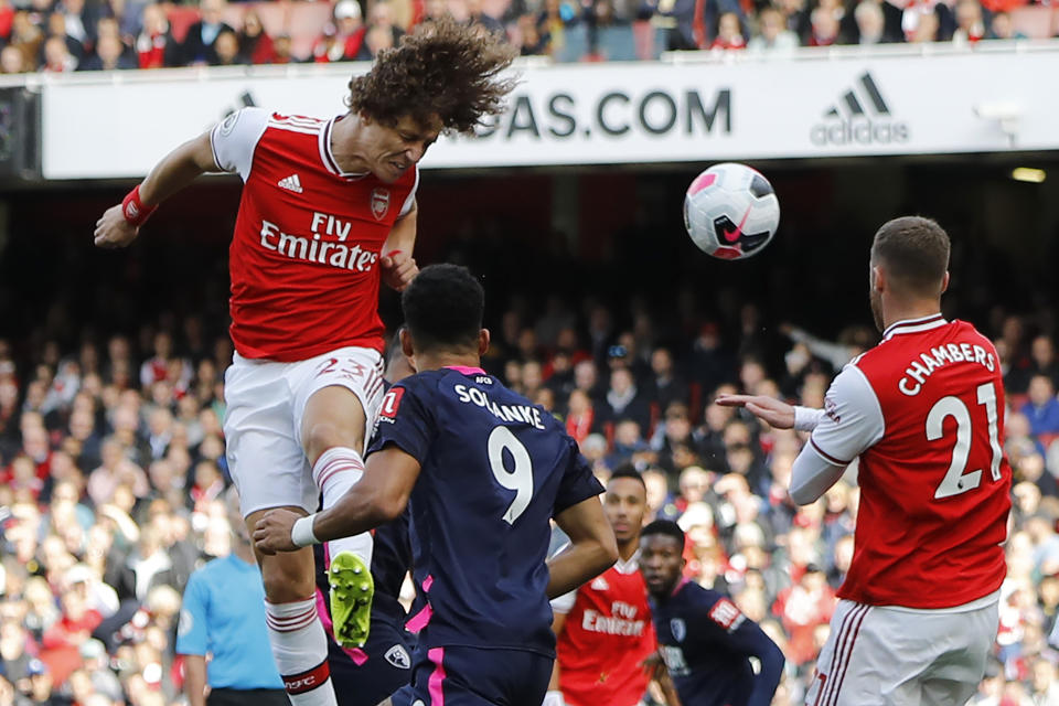 Asenal's Brazilian defender David Luiz (L) jumps to head home the opening goal of the English Premier League football match between Arsenal and Bournemouth at the Emirates Stadium in London on October 6, 2019. (Photo by Tolga AKMEN / AFP) / RESTRICTED TO EDITORIAL USE. No use with unauthorized audio, video, data, fixture lists, club/league logos or 'live' services. Online in-match use limited to 120 images. An additional 40 images may be used in extra time. No video emulation. Social media in-match use limited to 120 images. An additional 40 images may be used in extra time. No use in betting publications, games or single club/league/player publications. /  (Photo by TOLGA AKMEN/AFP via Getty Images)