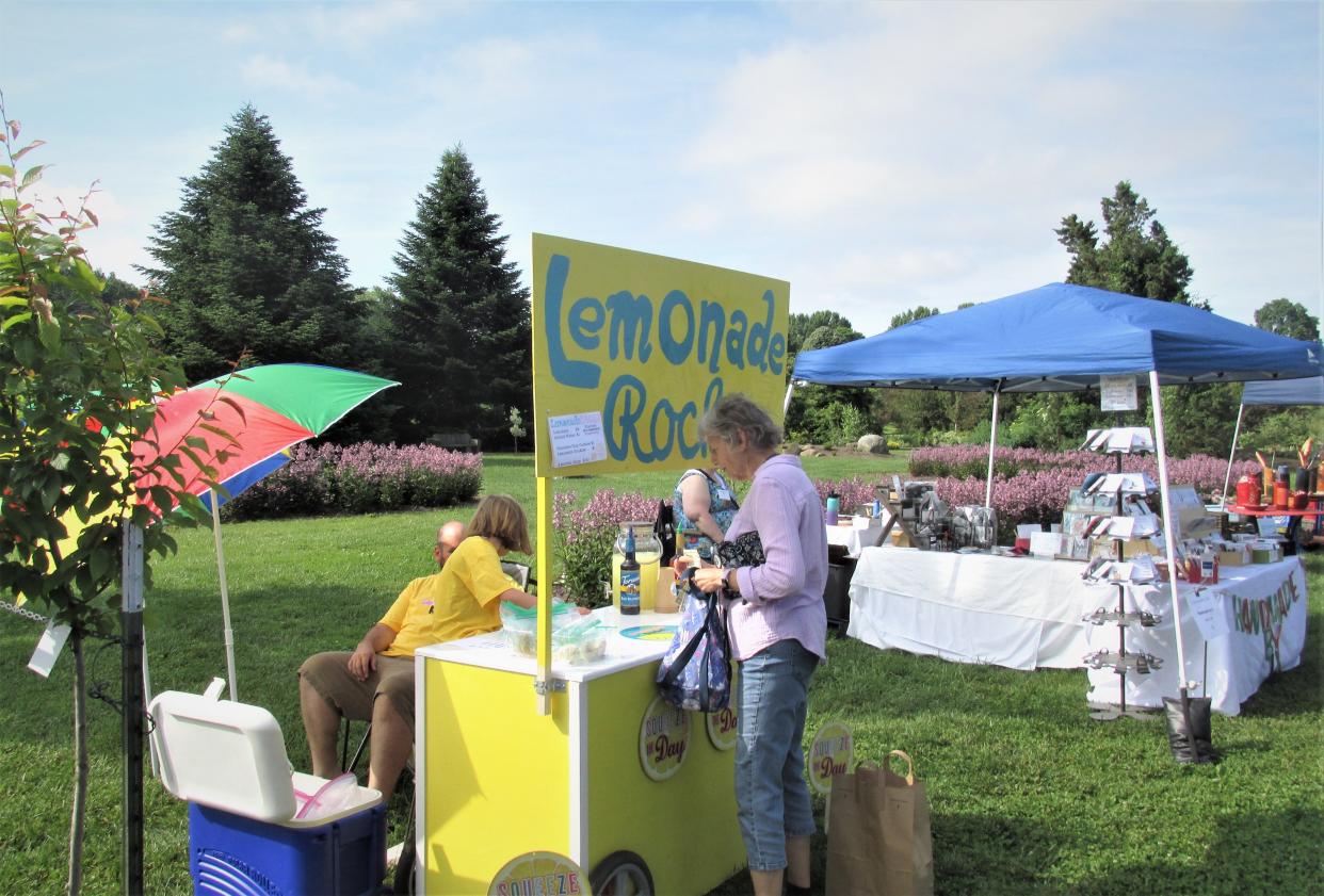 Addie Peterson had a prime location for her Lemonade Rocks stand at Secrest Arboretum on Saturday, where Linda Barbo of Wooster was a happy customer.