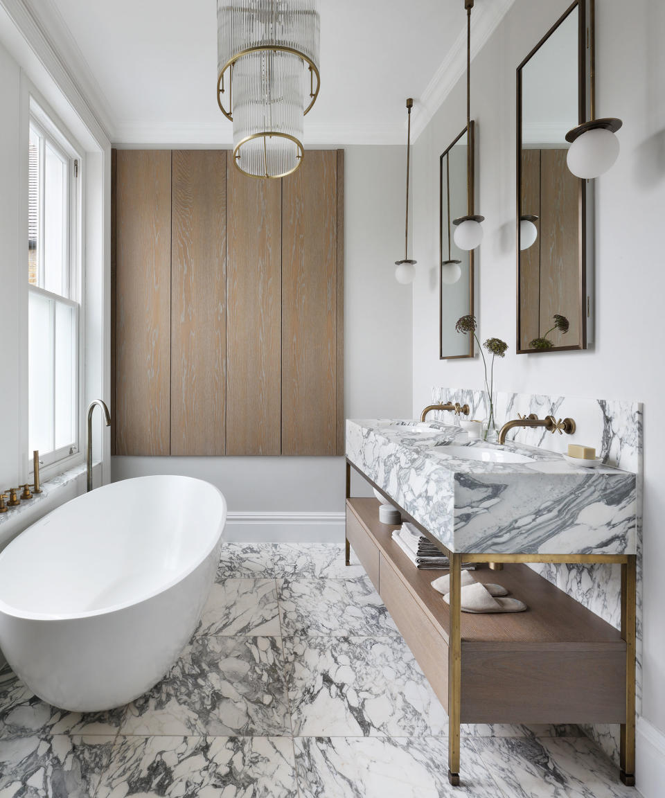 Modern bathroom with marble flooring, vanity and wood storage