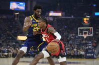 Houston Rockets guard Jalen Green (4) tries to get around Golden State Warriors forward Andrew Wiggins (22) during the first half of an NBA basketball game in San Francisco, Saturday, Dec. 3, 2022. (AP Photo/Godofredo A. Vásquez)