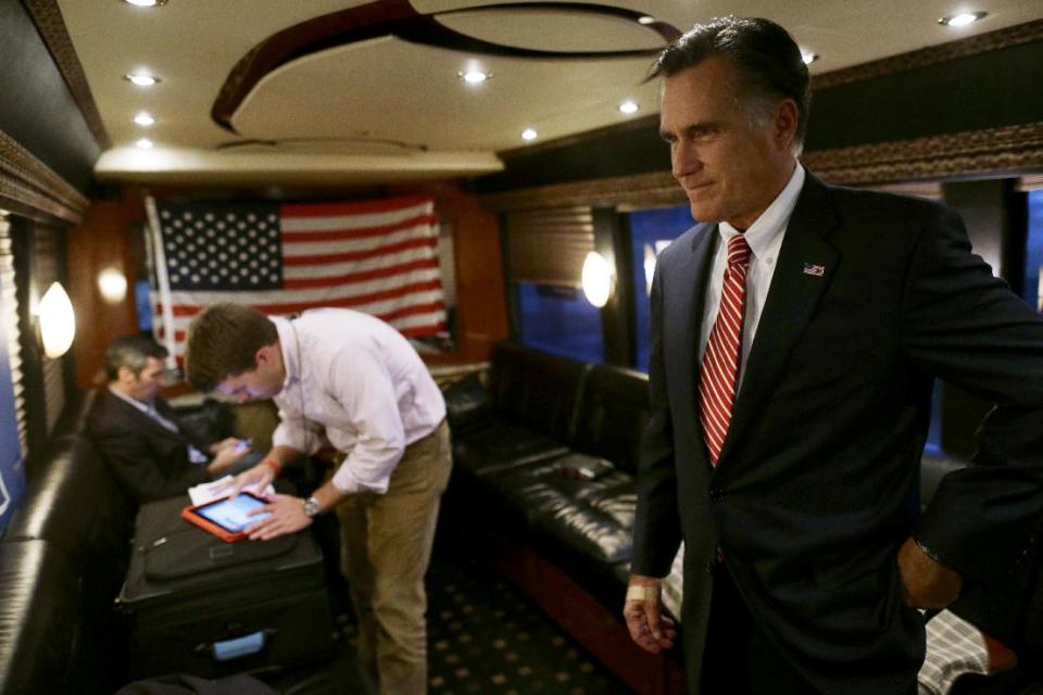 Republican presidential candidate, former Massachusetts Gov. Mitt Romney holds on in the back of his campaign bus with aide Garrett Jackson, center, and senior adviser Kevin Madden, left, after a campaigning at Meadow Event Park in Richmond, Va., Thursday, Nov. 1, 2012. (AP Photo/Charles Dharapak)