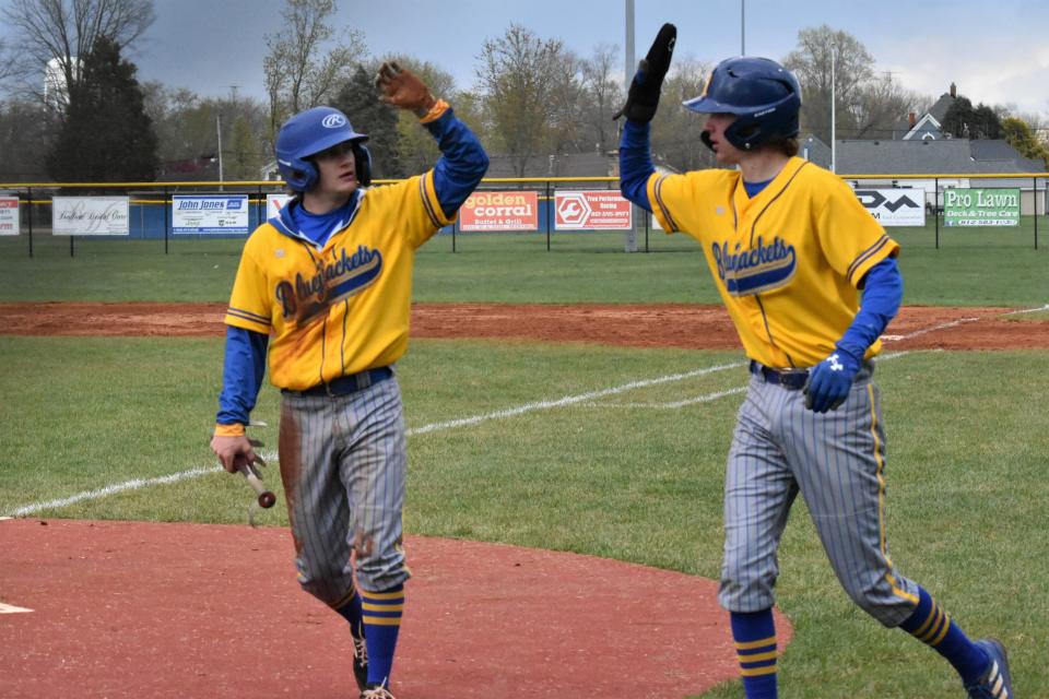 Dayson Martin (left) and Ben Seitzinger (right) high-five after scoring against Crawford County.