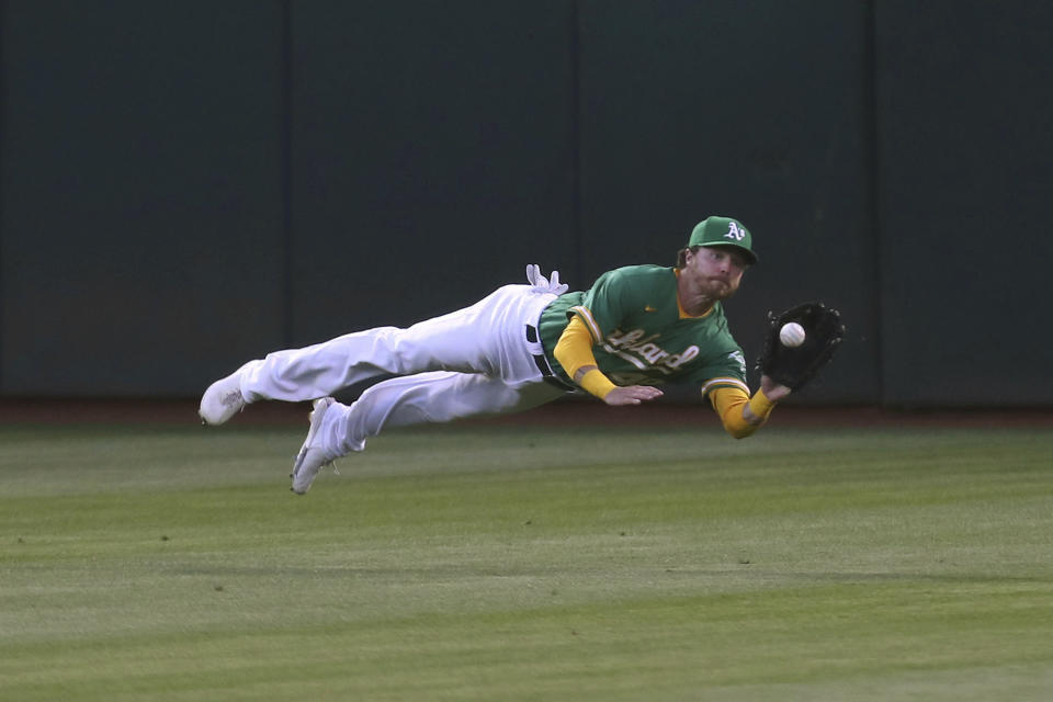 Oakland Athletics' Skye Bolt catches a ball hit by Los Angeles Angels' Jared Walsh during the sixth inning of a baseball game in Oakland, Calif., Tuesday, June 15, 2021. (AP Photo/Jed Jacobsohn)