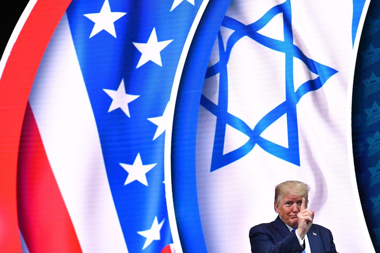 US President Donald Trump stands on stage after his address to the Israeli American Council National Summit 2019 at the Diplomat Beach Resort in Hollywood, Florida on December 7, 2019.