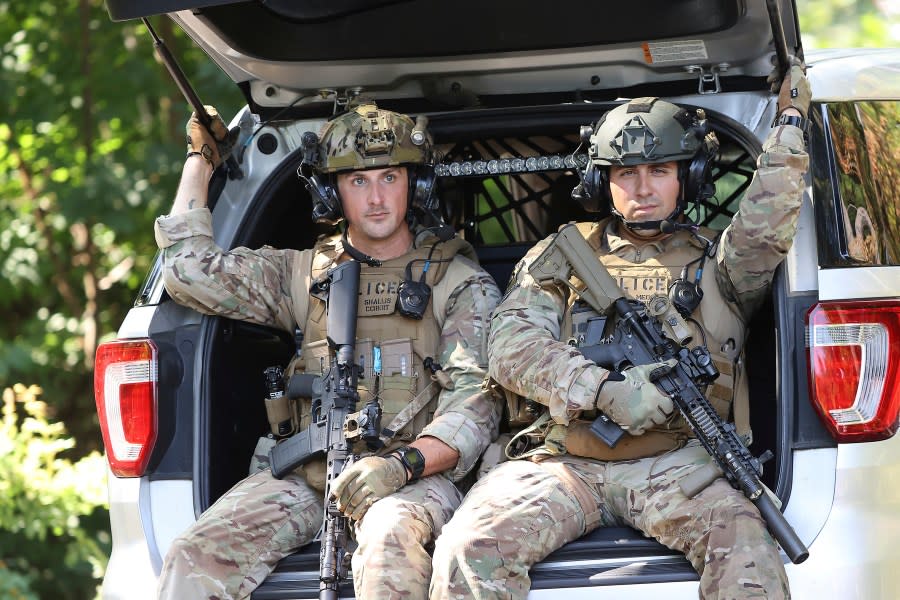 Heavily armed law enforcement officers move along Rt. 52 as the search continues for Danelo Cavalcante in Pocopson Township, Pa., on Sunday, Sept. 3, 2023. Cavalcante escaped from the Chester County Prison. Cavalcante was able to escape a prison yard in suburban Pennsylvania last week by climbing up a wall and over razor wire, officials said at a news conference Wednesday. (David Maialetti/The Philadelphia Inquirer via AP)