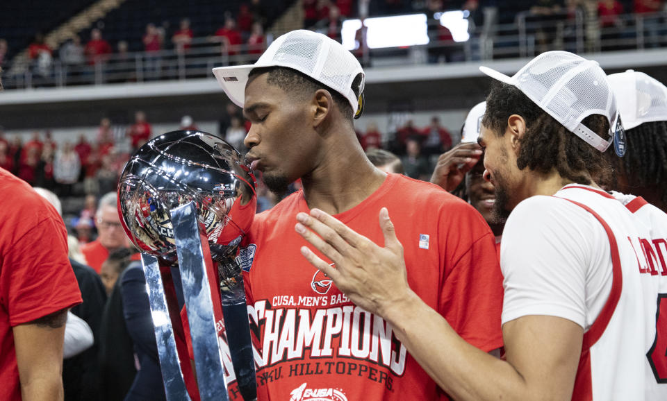 Western Kentucky redshirt senior guard Brandon Newman (10) kisses the Conference USA men's basketball championship trophy after the Hilltoppers won 78-71 over the UTEP Miners to become the Conference USA men's basketball champions for the first time since 2013 at VBC Propst Arena in Huntington, Ala., on Saturday, March 16, 2024. WKU advances the NCAA tournament. (Grace Ramey/Daily News via AP)