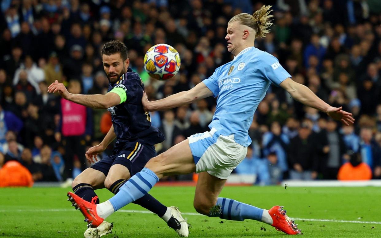 Nacho clears under pressure from Erling Haaland