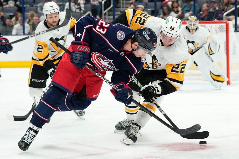 Oct 3, 2024; Columbus, Ohio, USA; Columbus Blue Jackets center Sean Monahan (23) takes a face off against Pittsburgh Penguins right wing Sam Poulin (22) during the third period of the NHL hockey game at Nationwide Arena. The Blue Jackets lost 3-1.