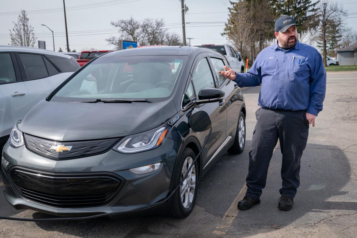 Bowman Chevrolet technician, Zach Vanwert 37, of Swartz Creek, talks about purchasing a used 2020 Chevrolet Bolt EV in the parking lot of his employer in Clarkston on Wednesday, April 10, 2024.