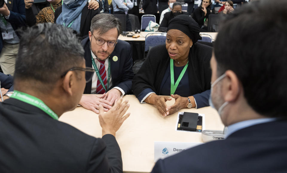 Eve Bazaiba Masudi, Vice-Prime Minister and Environment Minister of the Democratic Republic of Congo and Brazil Foreign Minister Leonardo Cleaver de Athayde, left, confer with other delegates at the COP15 U.N. conference on biodiversity in Montreal, on Monday, Dec. 19, 2022. (Paul Chiasson/The Canadian Press via AP)