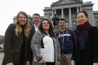 In this Tuesday, Jan. 21, 2020, photograph, from left, Stephanie Cain, Matthew McAllister, Janell Schafer, Kelly Taylor and Yeri Kim, all members of the Colorado Digital Service, are shown outside the State Capitol in downtown Denver. (AP Photo/David Zalubowski)