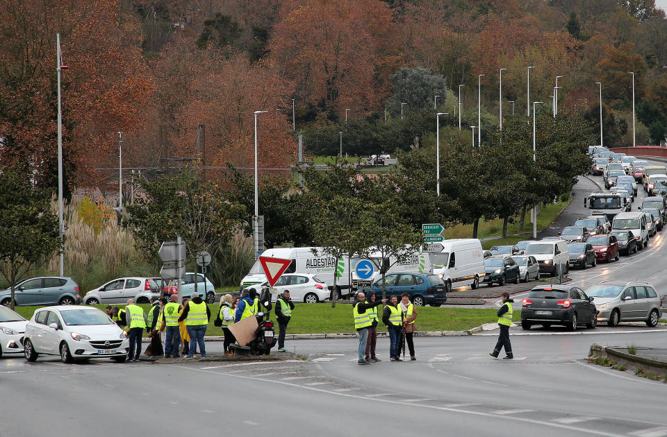 Demonstrators block cars in Bayonne, southwestern France, Sunday, Nov. 18, 2018. One protester was killed and 227 other people were injured — eight seriously — at roadblocks set up around villages, towns and cities across France on Saturday as citizens angry with rising fuel taxes rose up in a grassroots movement, posing a new challenge to beleaguered President Emmanuel Macron. (AP Photo/Bob Edme)