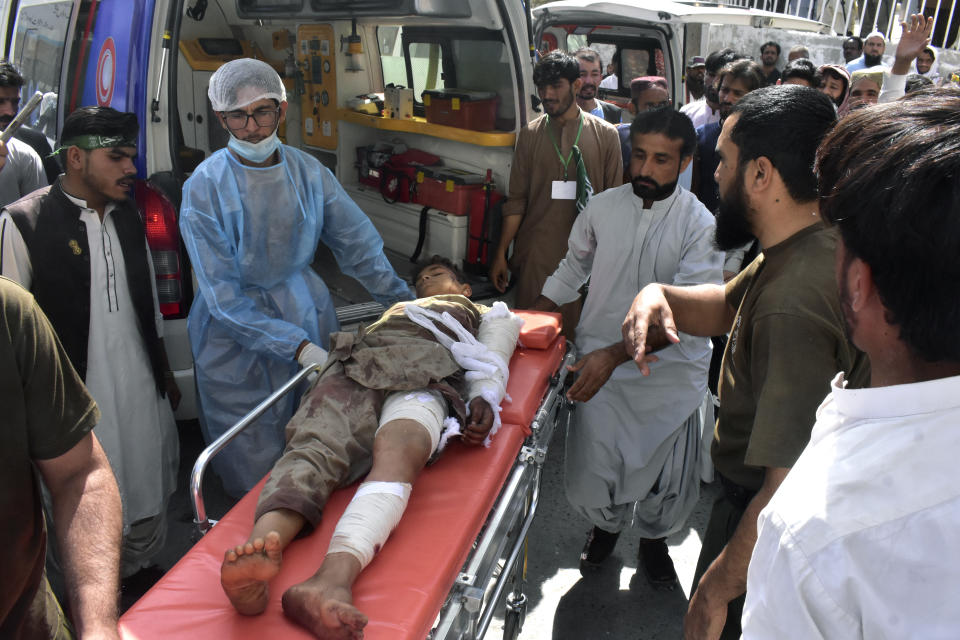 Paramedics and volunteers transport an injured victim of a bomb explosion upon arrival at a hospital, in Quetta, Pakistan, Friday, Sept. 29, 2023. A powerful bomb exploded at a rally celebrating the birthday of Islam's Prophet Muhammad in southwest Pakistan on Friday, killing multiple people and wounding dozens of others, police and a government official said. (AP Photo/Arshad Butt)