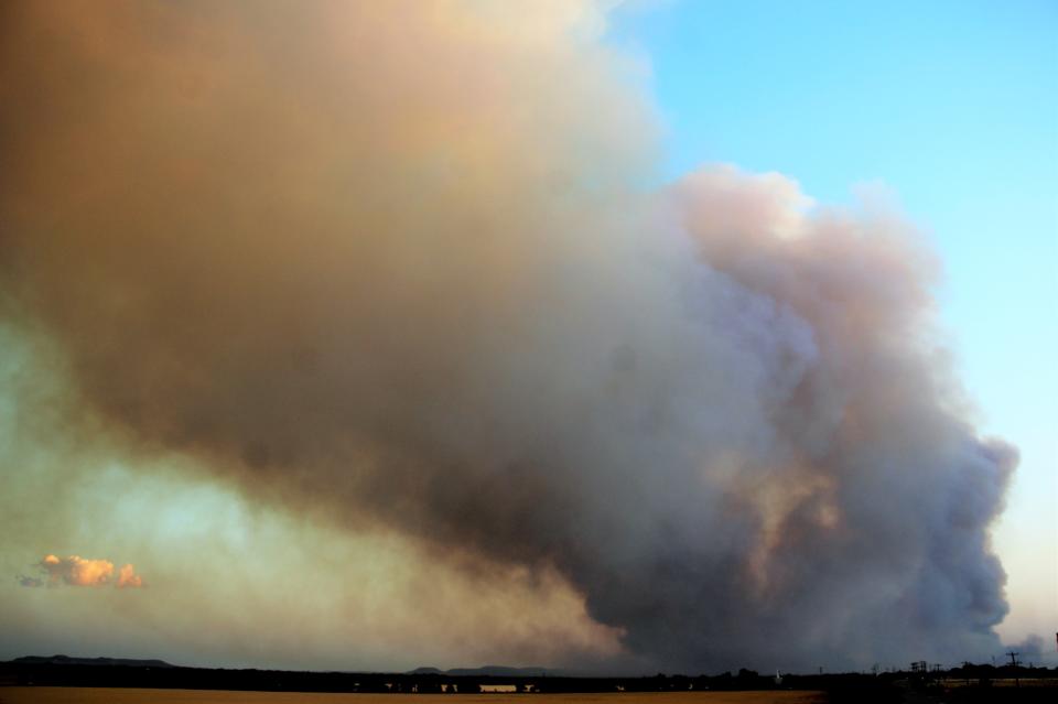 Smoke rises from a wildfire southwest of Abilene in May. The Texas A&M Forest Service warns that hot and dry conditions across Texas will create a high potential for wildfires in the state through the weekend.