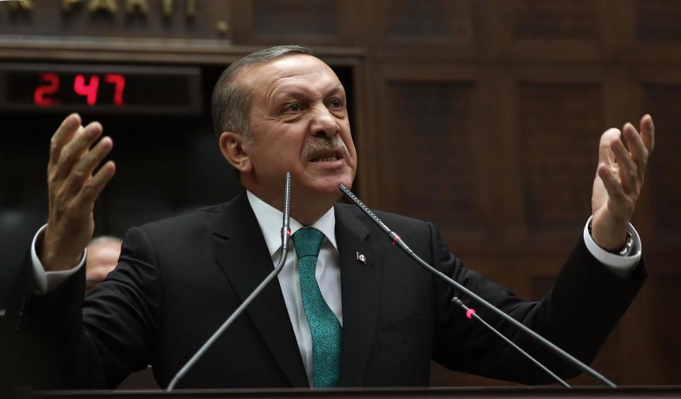 Turkey's Prime Minister Recep Tayyip Erdogan addresses his supporters at the parliament in Ankara, Turkey, Tuesday, Jan. 14, 2014. Turkish anti-terrorism police carried out raids in six cities on Tuesday, detaining at least five people with alleged links to al-Qaida, including an employee of a prominent Islamic charity group that provides aid to Syria, media reports and officials said.(AP Photo)