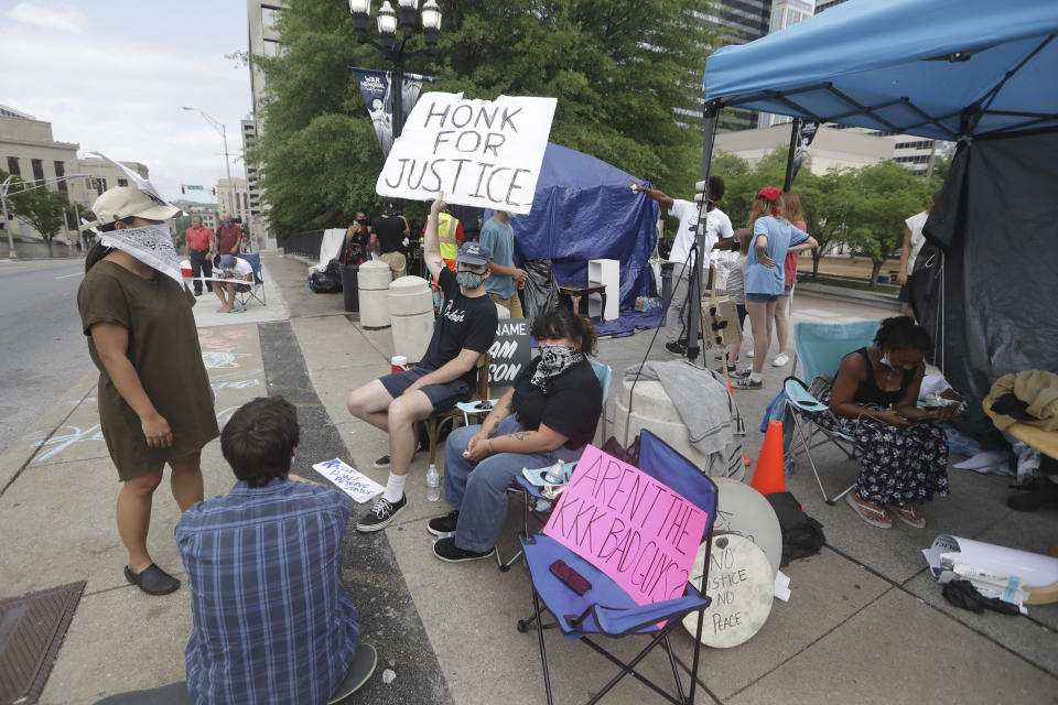 Demonstrators protest across the street from the Capitol Wednesday, July 1, 2020, in Nashville, Tenn. Under Tennessee's newest law, a wide range of crimes commonly associated with protests will see a big bump in penalties and fines, but the most contentious element focuses on escalated penalties for illegal camping. Violators will now face a Class E felony, punishable by up to six years in prison. (AP Photo/Mark Humphrey)