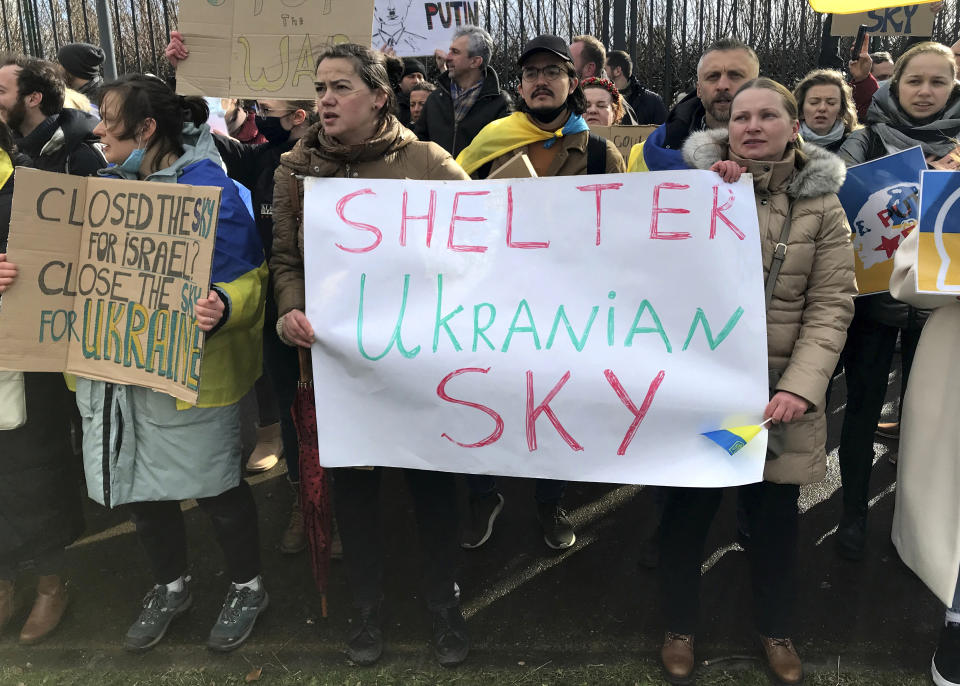 Protestors take part in a demonstration outside a NATO leaders virtual summit at NATO headquarters in Brussels, Friday, Feb. 25, 2022. U.S. President Joe Biden and his NATO counterparts will seek Friday to reassure member countries on the alliance's eastern flank that their security is guaranteed as Russia's large-scale invasion of Ukraine closes in on the capital Kyiv. (AP Photo/Mark Carlson)