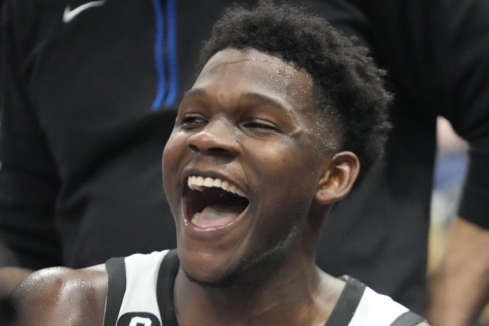 Minnesota Timberwolves guard Anthony Edwards smiles as he sits on the bench during the second half of an NBA basketball game against the Utah Jazz Wednesday, Feb. 8, 2023, in Salt Lake City. (AP Photo/Rick Bowmer)