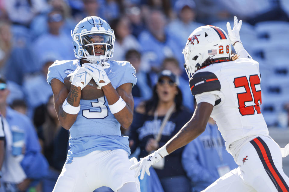 North Carolina wide receiver Chris Culliver (3) catches a touchdown pass ahead of Campbell cornerback Ronald Bullard (26) in the second half of an NCAA college football game in Chapel Hill, N.C., Saturday, Nov. 4, 2023. North Carolina won 59-7. (AP Photo/Nell Redmond)