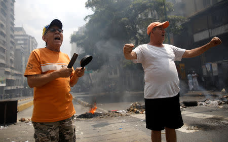 Demonstrators shout at a protest against the government of Venezuelan President Nicolas Maduro in Caracas, Venezuela March 31, 2019. REUTERS/Carlos Garcia Rawlins