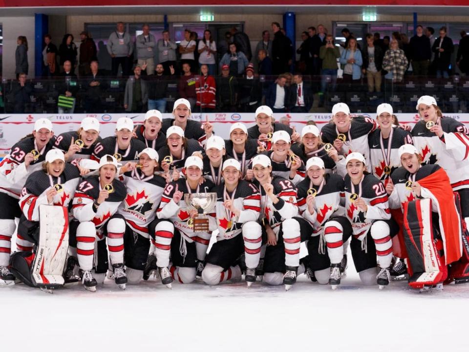 The Canadian women's hockey team pose with the trophy and their gold medals following their 2-1 win over the United States on Sunday in the women's hockey world championship final in Herning, Denmark (Bo Amstrup/Ritzau Scanpix via The Associated Press - image credit)