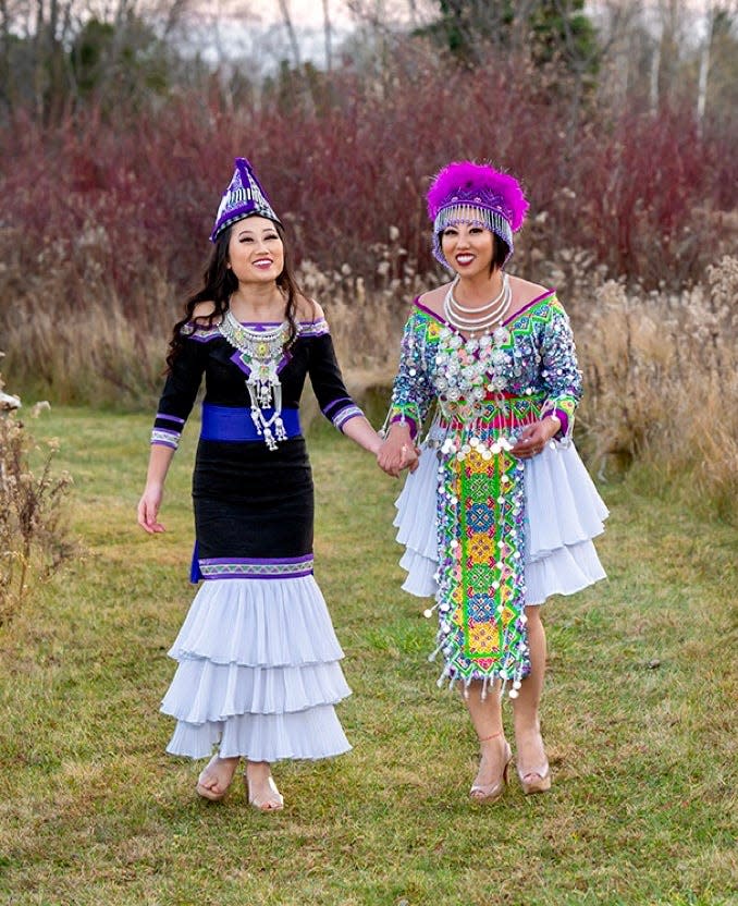 Kaonou Hang-Vue (right) and her daughter, Anastasia Vue, wear modern Hmong clothes, with hats that don't need to be wrapped like a traditional turban, lightweight necklaces and sashes that can be pinned instead of tied.