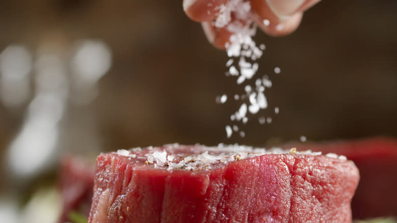 salting beef close up