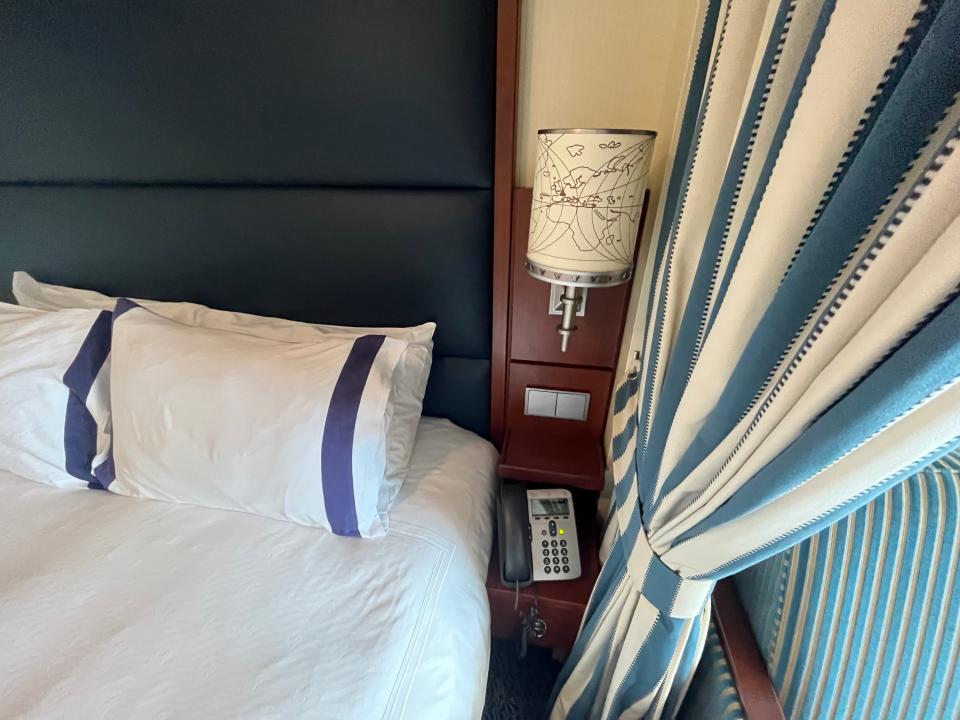 disney dream deluxe ocean-view stateroom with a verandah bedside lamp