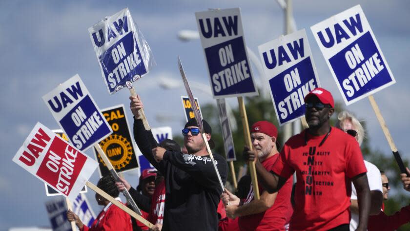 United Auto Workers members walk the picket line at the Ford Michigan Assembly Plant in Wayne, Mich., Monday, Sept. 18, 2023. So far the strike is limited to about 13,000 workers at three factories — one each at GM, Ford and Stellantis. (AP Photo/Paul Sancya)