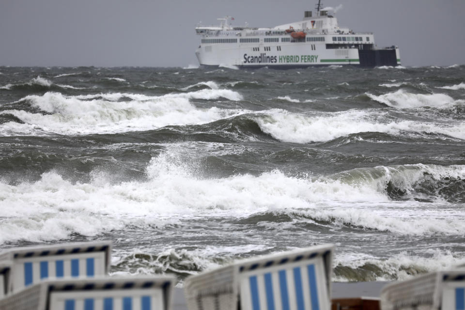 A ferry leaves the harbour as high waves are seen on the Baltic Sea in Warnemuende, eastern Germany, on a stormy Monday, Sept.30, 2019. (Bernd Wuestneck/dpa via AP)