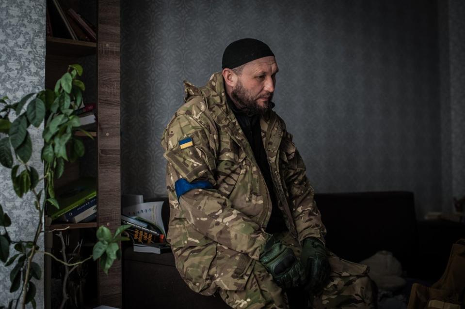 Kamil, a member of the territorial defense of Kyiv, in his friend’s apartment in Bucha which was occupied by Russians (Alina Smutko)