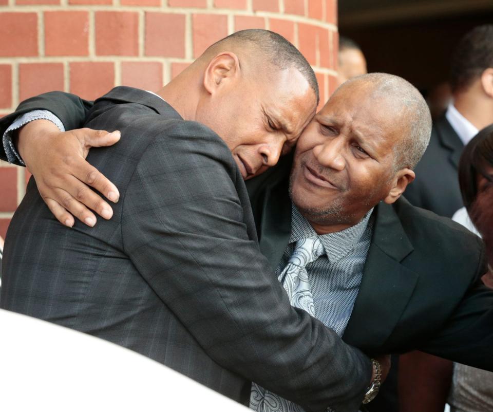 clarence franklin hugging a funeral attended with his right arm