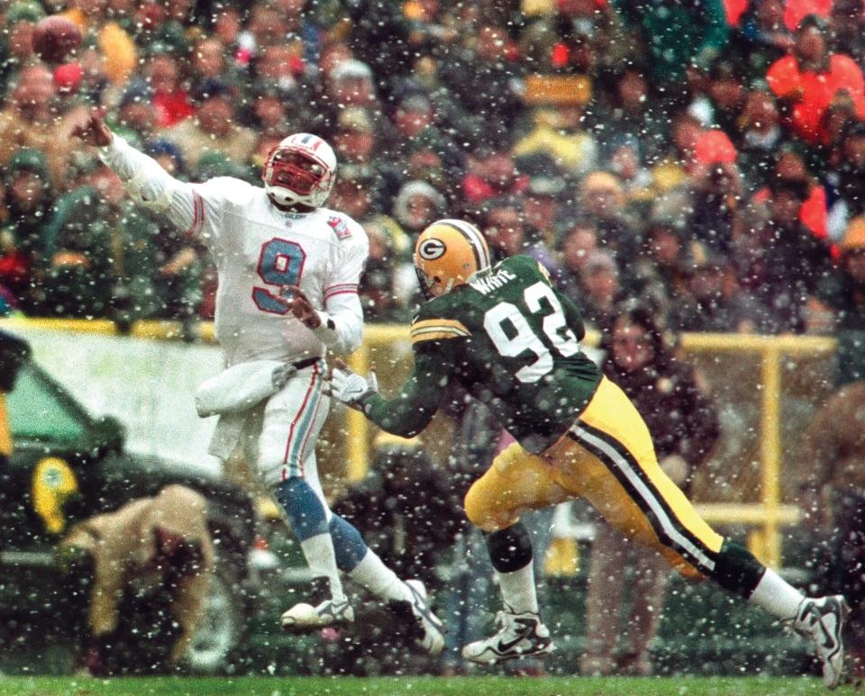 Green Bay Packers defensive end Reggie White applies pressure to Tennessee Oilers quarterback Steve McNair as he throws a pass in the second quarter on Sunday, Dec. 20, 1998, in Green Bay, Wis. The game will likely be White's last at Lambeau field, who says he is retiring at the end of the season.