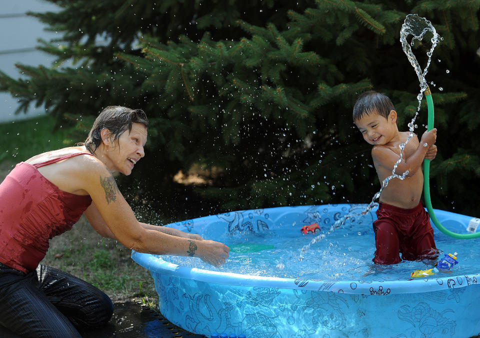 Shawn Patrick Willis, Jr., 2, sprays his grandma, Deanna Willis, on Wednesday, August 29, 2012 in the front yard of their home in Sioux Falls, S.D. (AP Photo/The Argus Leader, Jay Pickthorn) NO SALES