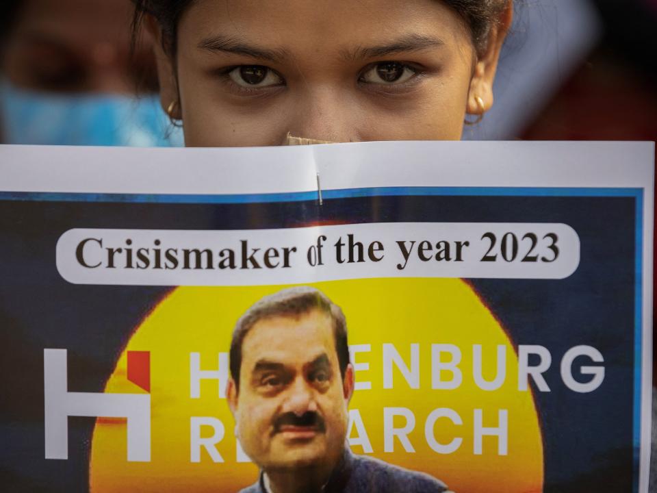 An activist of the youth wing of India's main opposition Congress party holds a placard featuring Gautam Adani, chairman of Adani Group, during a protest against what they say are investments by Life Insurance Corporation (LIC) and State Bank of India (SBI) in Adani Group, in New Delhi, India, February 6, 2023.
