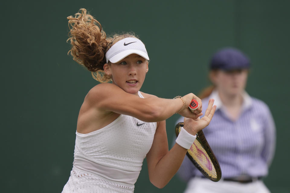 Russia's Mirra Andreeva plays a return to Russia's Anastasia Potapova during the women's singles match on day seven of the Wimbledon tennis championships in London, Sunday, July 9, 2023. (AP Photo/Alberto Pezzali)