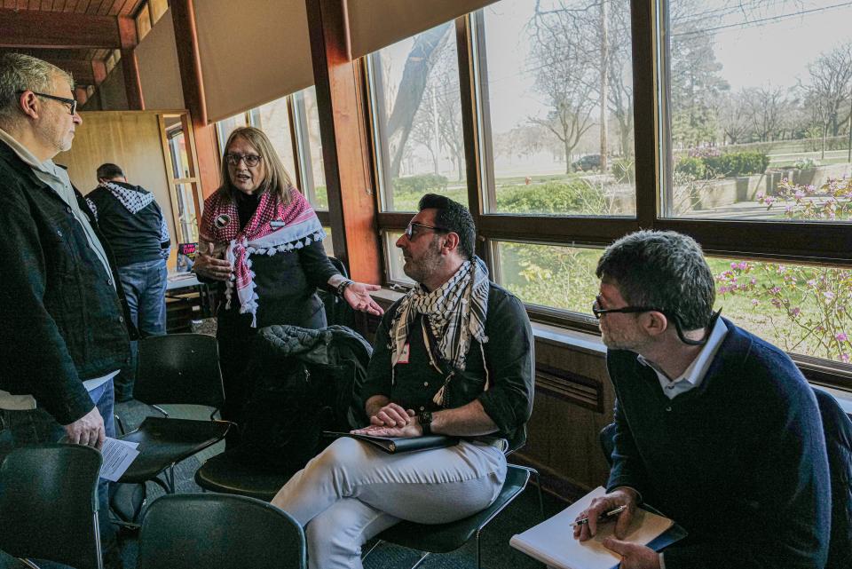 Laura Sager talks with some of the panelists at the "The Path to a Free Palestine: History, Crisis, and Action" event at University United Methodist Church in East Lansing on Saturday, April 13, 2024.