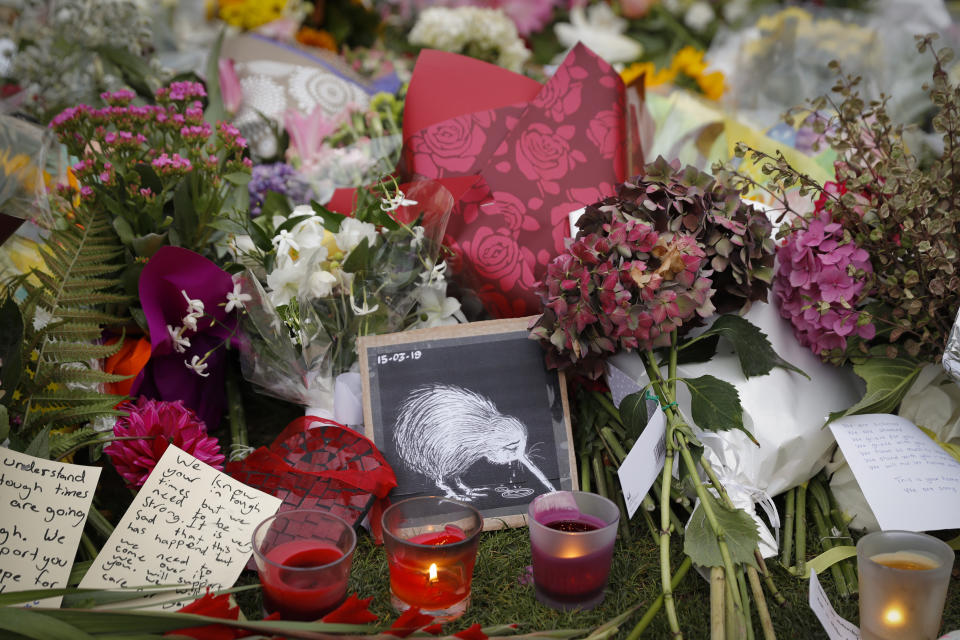 Mourners lay flowers on a wall at the Botanical Gardens in Christchurch. Source: AP