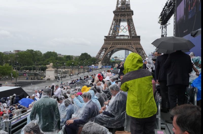 Spectators near the Eiffel Tower wait for the start of the Opening Ceremony of the Games. Photo by Richard Ellis/UPI