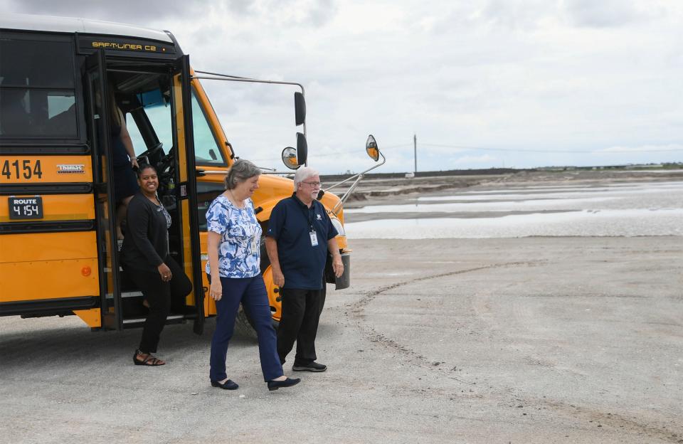 St. Lucie School's School Board members (from right) Jack Kelly and Debbie Hawley step off a school bus with other community members to tour the site of the nest St. Lucie School's public high school, referred to as Tradition DDD, located along Ridge Line Road on Wednesday, March 31, 2023, in southern Port St. Lucie. Currently St. Lucie Schools has five public high schools With Fort Pierce Central and Fort Pierce Westwood in Fort Pierce, and Port St. Lucie, St. Lucie West Centennial and Treasure Coast high schools in Port St. Lucie.