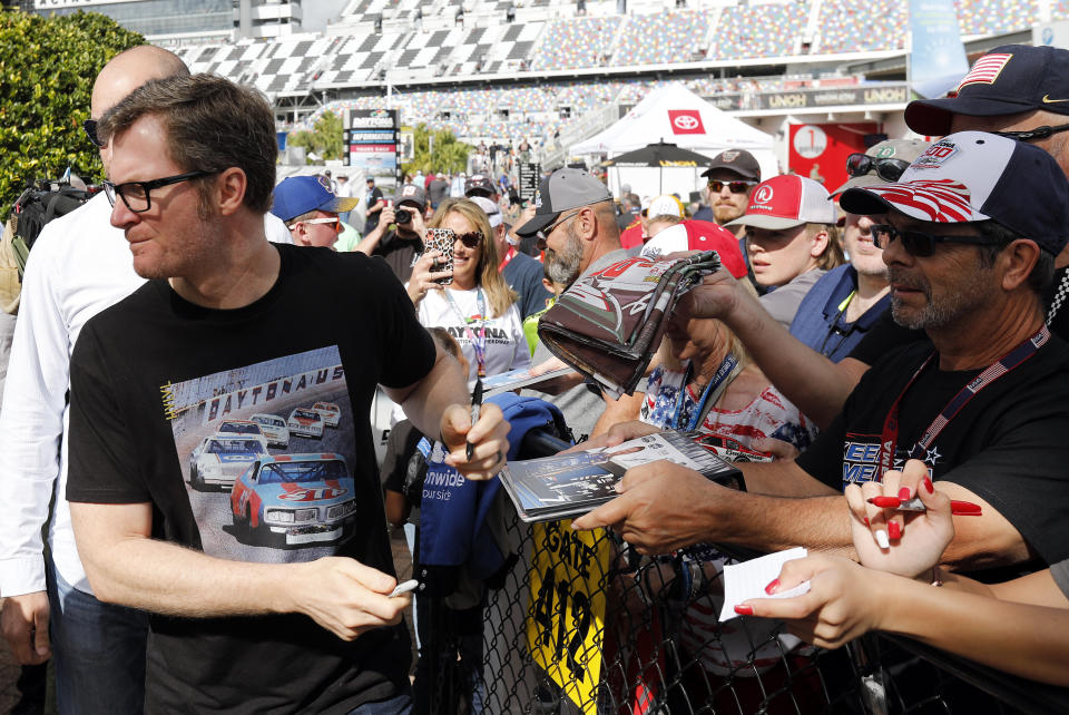 Dale Earnhardt Jr., team owner and TV analyst signs autographs outside the media center before the NASCAR Daytona 500 auto race at Daytona International Speedway, Sunday, Feb. 16, 2020, in Daytona Beach, Fla. (AP Photo/Terry Renna)