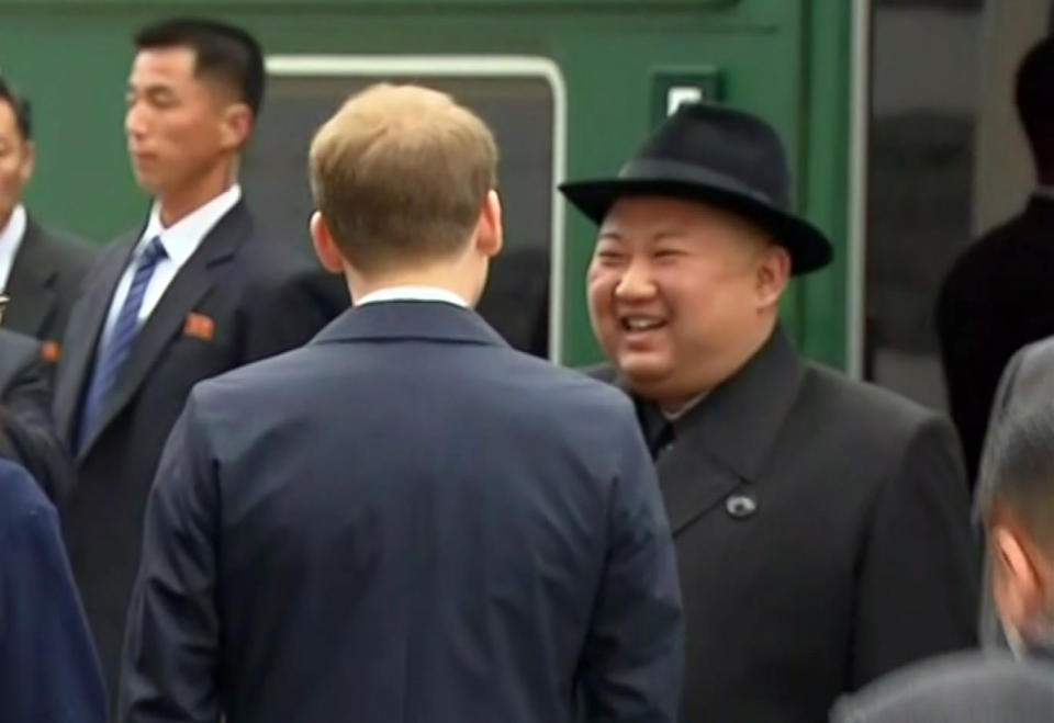 In this image taken from the RU-RTR Russian television, North Korean leader Kim Jong Un smiles as he leaves a train in Vladivostok railway station in Vladivostok, Russia, Wednesday, April 24, 2019. North Korean leader Kim Jong Un arrived in Russia by train on Wednesday, a day before his much-anticipated summit with President Vladimir Putin that comes amid deadlocked diplomacy on his nuclear program. (RU-RTR Russian Television via AP)